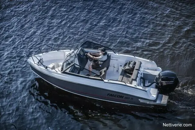 A person operates a white Falcon BR 3 boat on calm waters, showcasing outdoor recreation and boating activities.